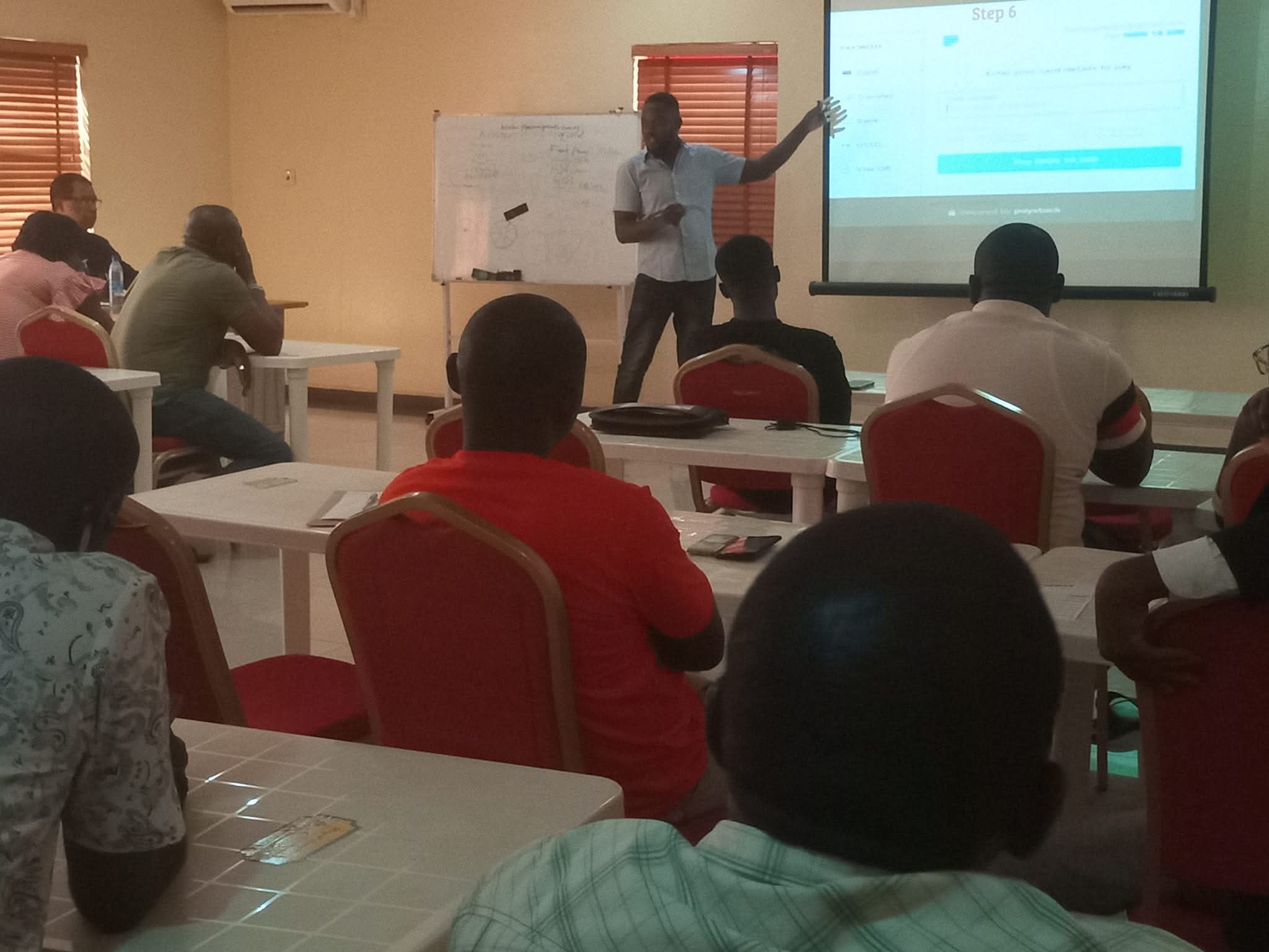 Bernard Okpe leading a fintech bootcamp session with participants learning digital payment solutions