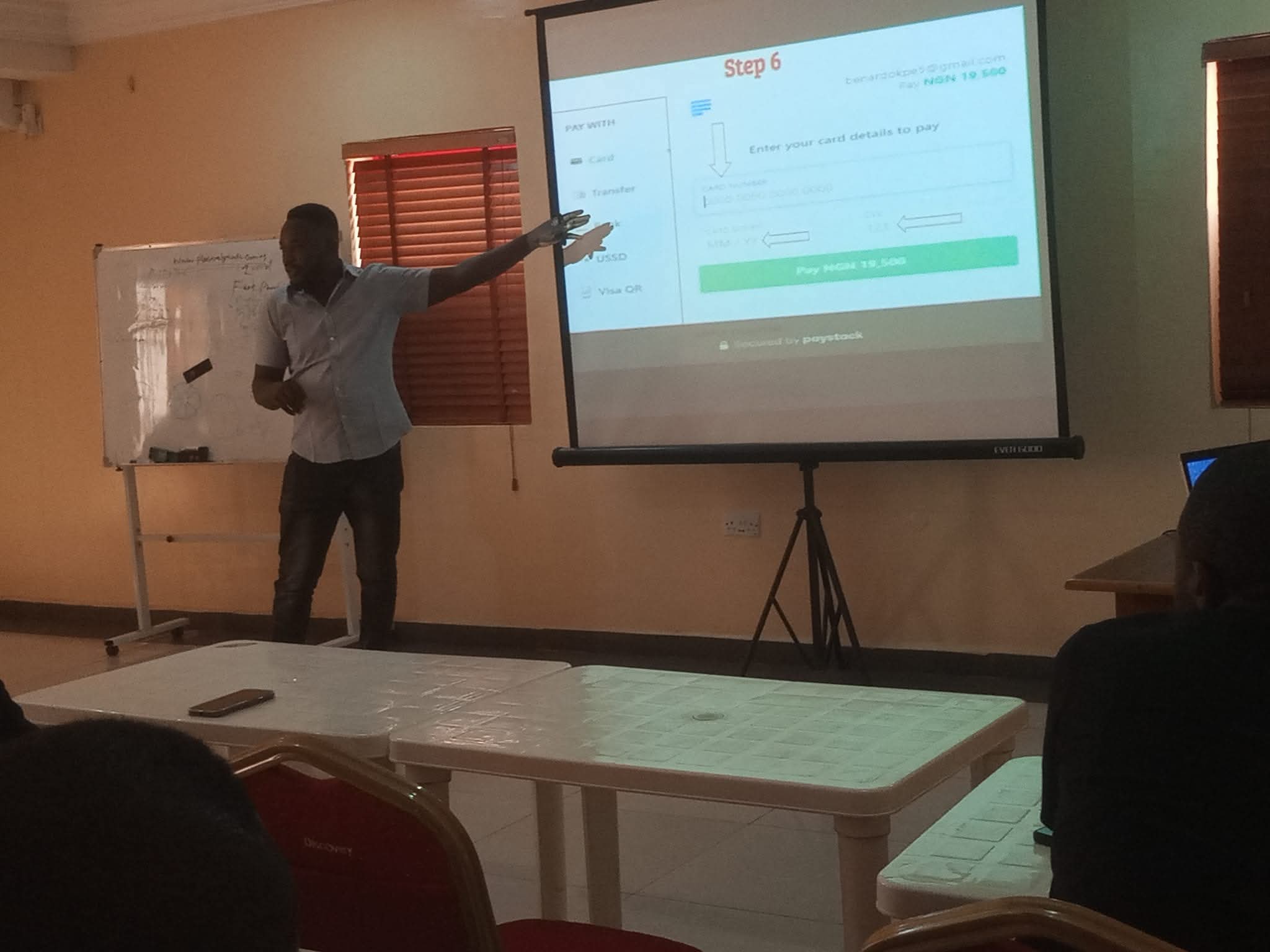 Bernard Okpe delivering a technical presentation on web development and digital solutions